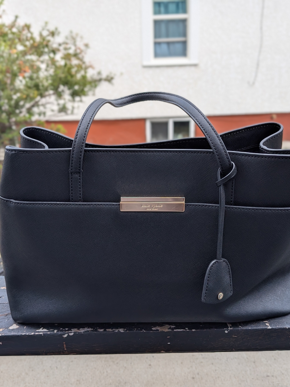 kate spade black tote with gold plaque